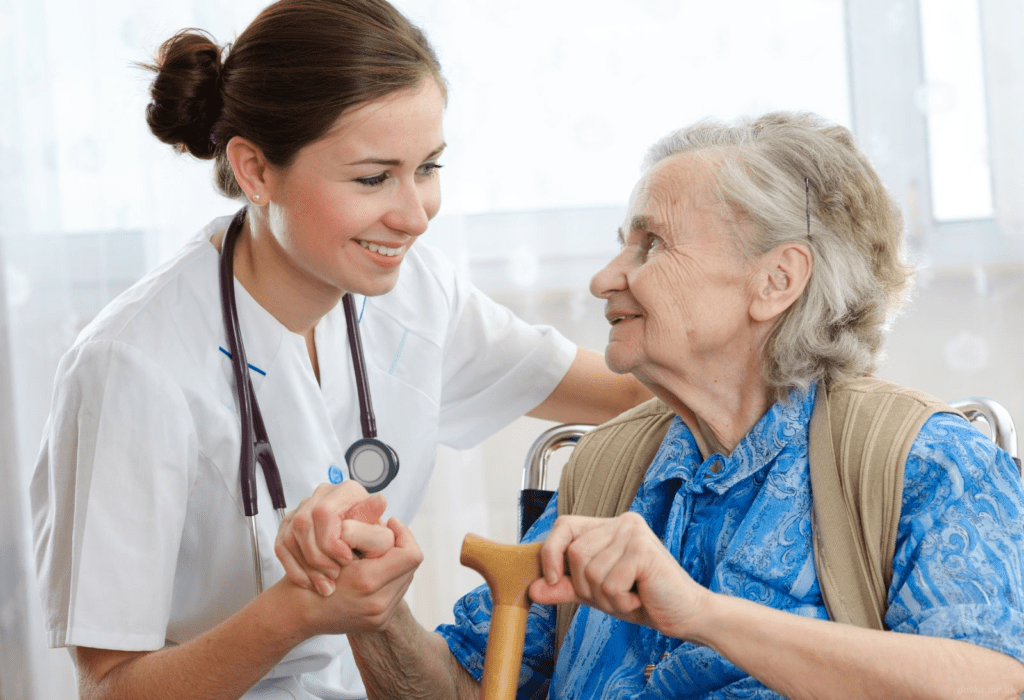 young nurse supporting an old lady